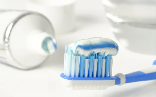 A toothbrush with a dollop of toothpaste on the bristles